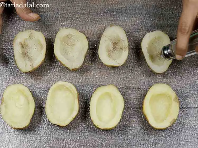 Step 11 – Sprinkle some salt and pepper powder over each potato halve.