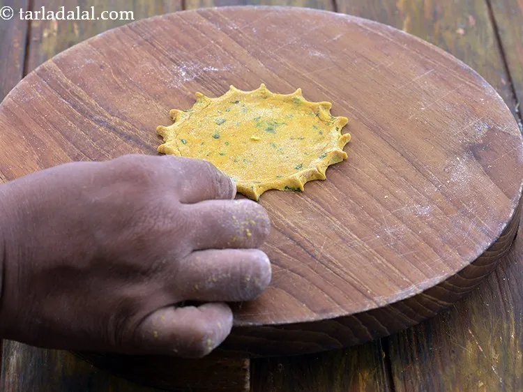 Step 26 – Pinch the edges of the rolled mathri to form a design.