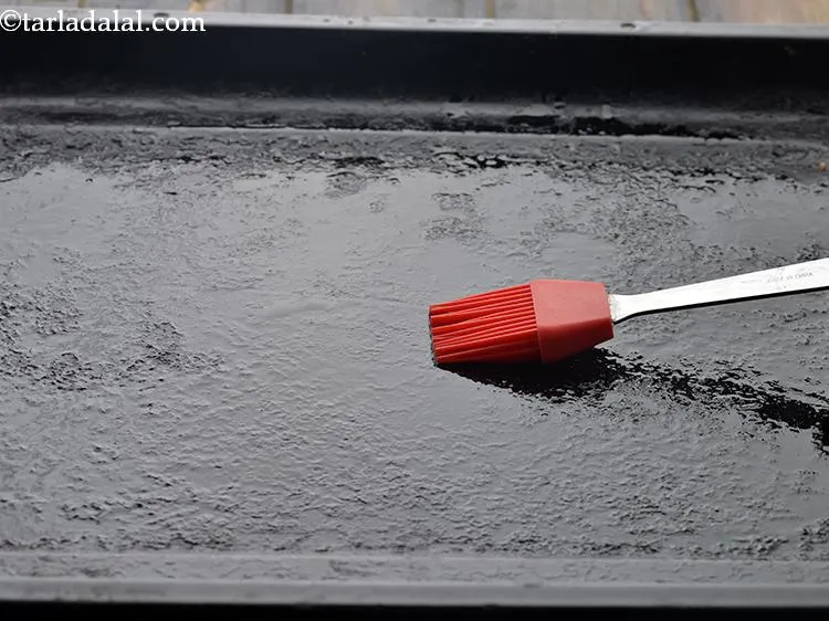 Step 16 – Grease the baking tray with oil.&nbsp;