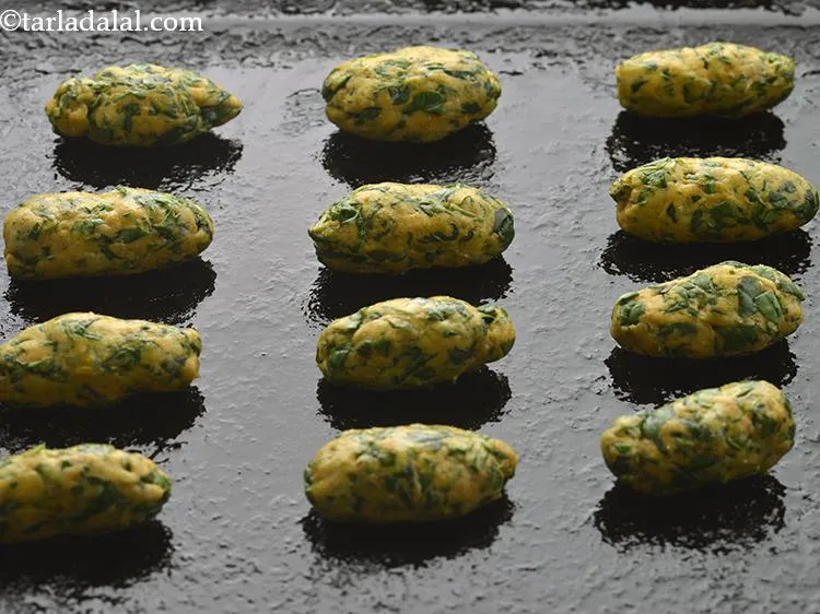 Step 17 – Place the Methi Muthia on the greased baking tray.