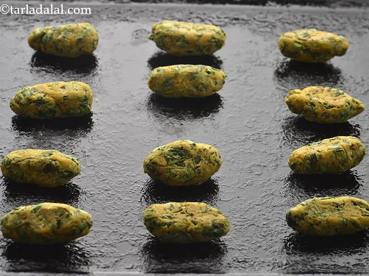 Step 19 – Turn the Methi Muthia over and bake them again for 5 minutes.