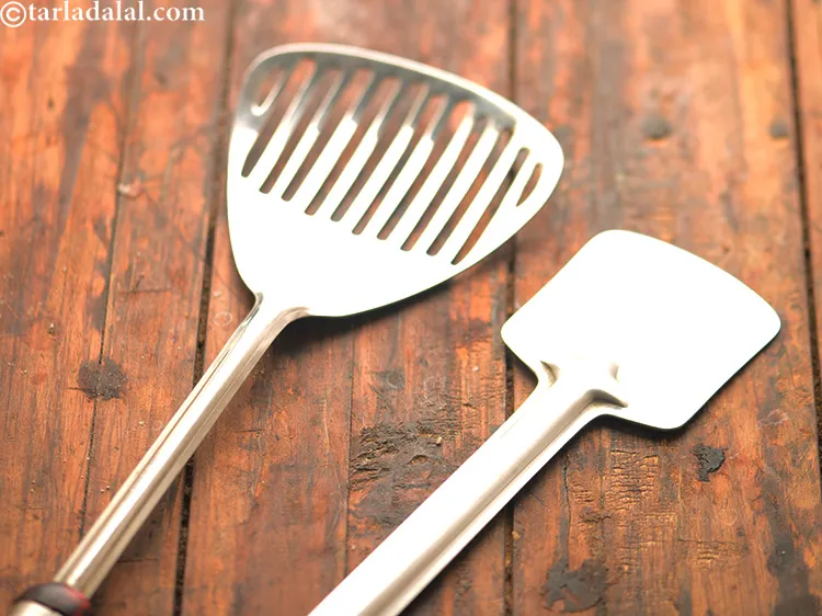 Step 19 – Use a flat ladle as shown in the image to transfer each chakli from the …