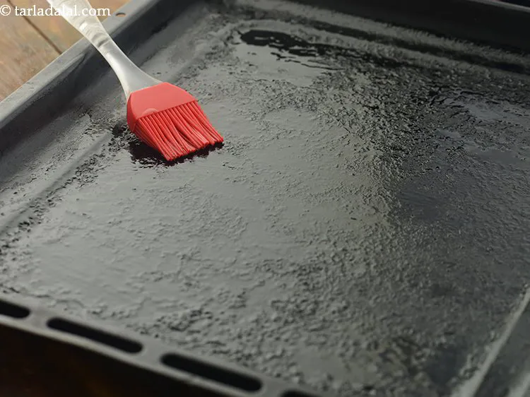 Step 15 – Grease a baking tray with oil.
