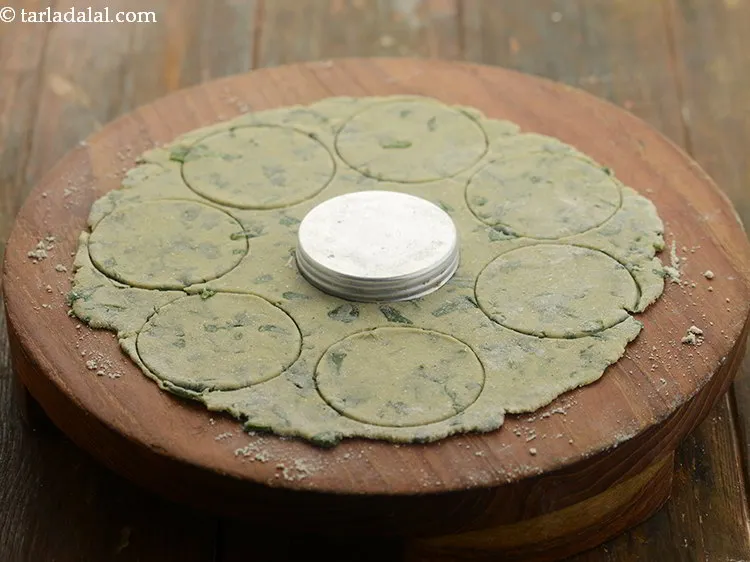 Step 12 – Take a small cookie cutter or vati of 1&frac34;&quot; and cut 8 small puris with …