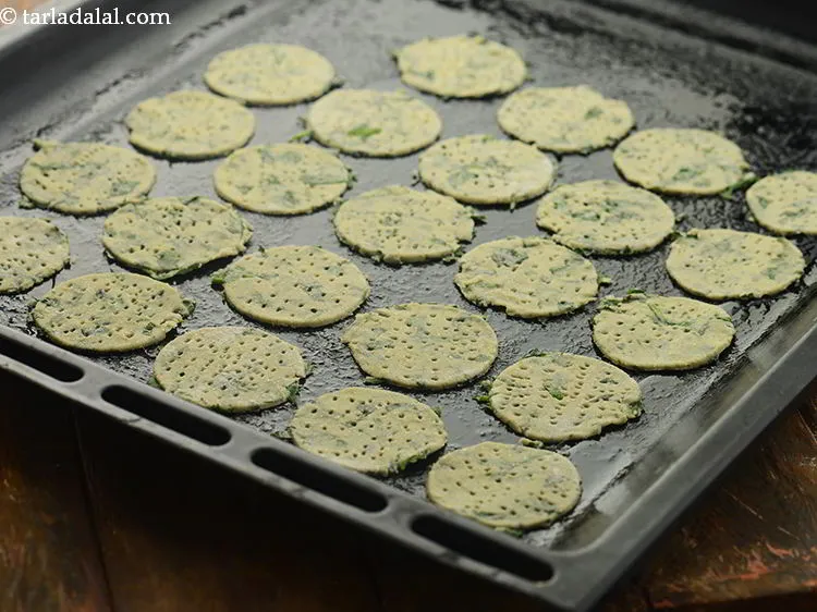 Step 16 – Place 22 <strong>methi palak puri</strong> on a baking tray.