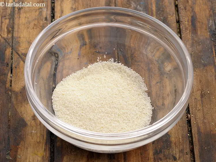 Step 1 – To begin making <strong>baked poha</strong>, in a small bowl take semolina.