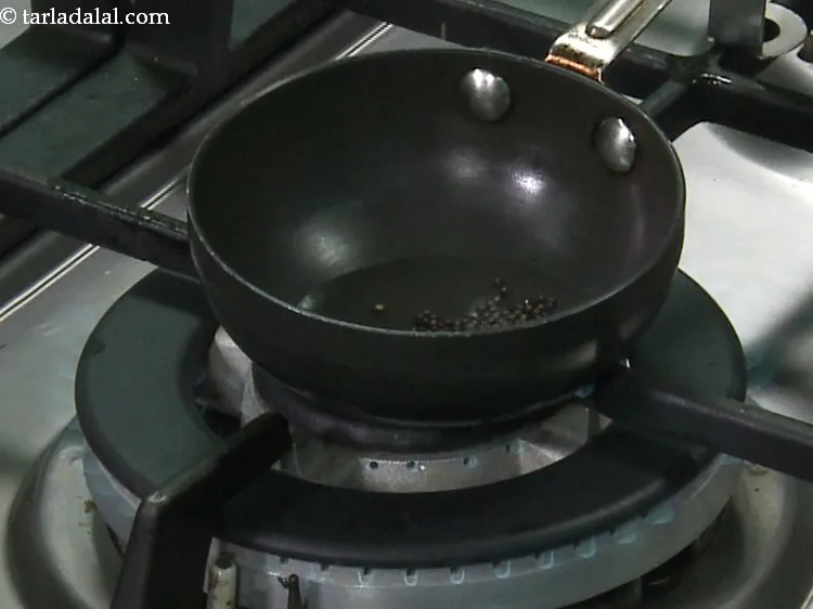 Step 18 – When the oil is hot, add the mustard seeds.