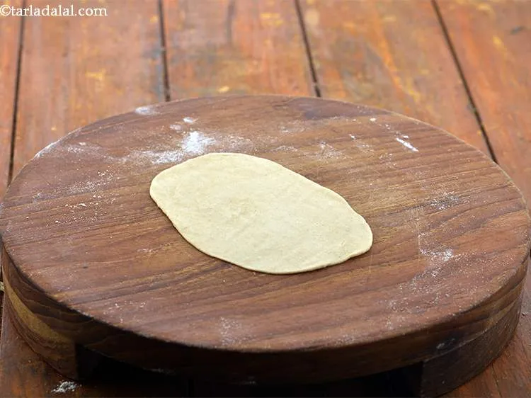 Step 11 – Roll out each portion into 4:3 oval thin chapatis.