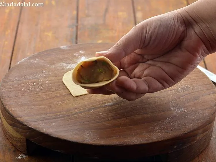 Step 26 – Stuff the cone with approx. 1 tbsp of stuff of the&nbsp;<strong>Baked Samosa</strong>&nbsp;stuffing. While stuffing ensure …