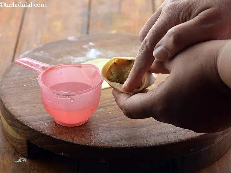 Step 27 – Seal the edges carefully using a little water. Keep aside.