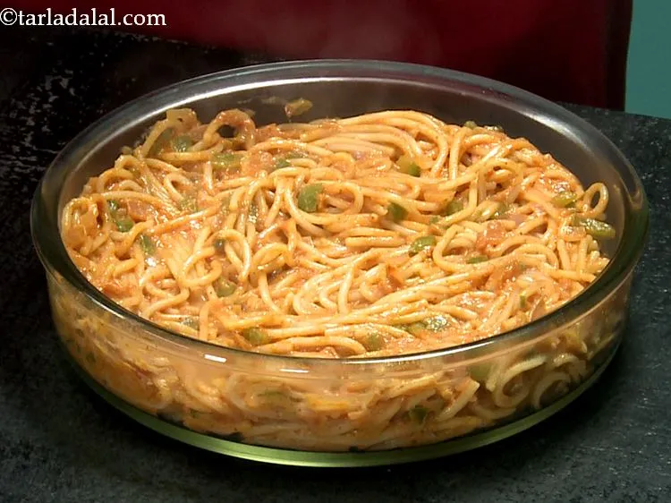 Step 22 – Pour the prepared spaghetti with tomato sauce into an ovenproof baking dish and spread it …