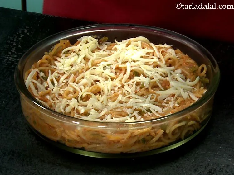 Step 23 – Sprinkle the grated cheese evenly over spaghetti.