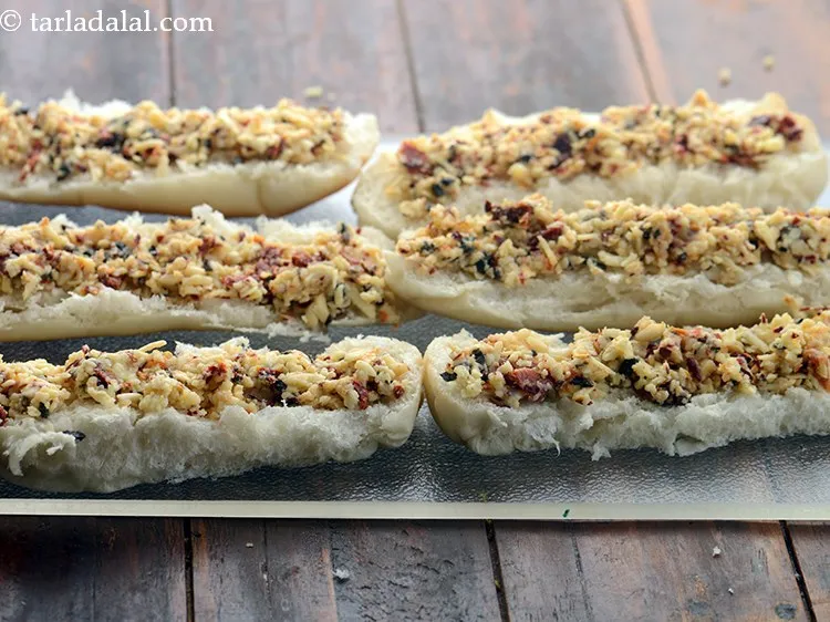 Step 13 – Spread a portion of the topping on each hot dog roll halves.