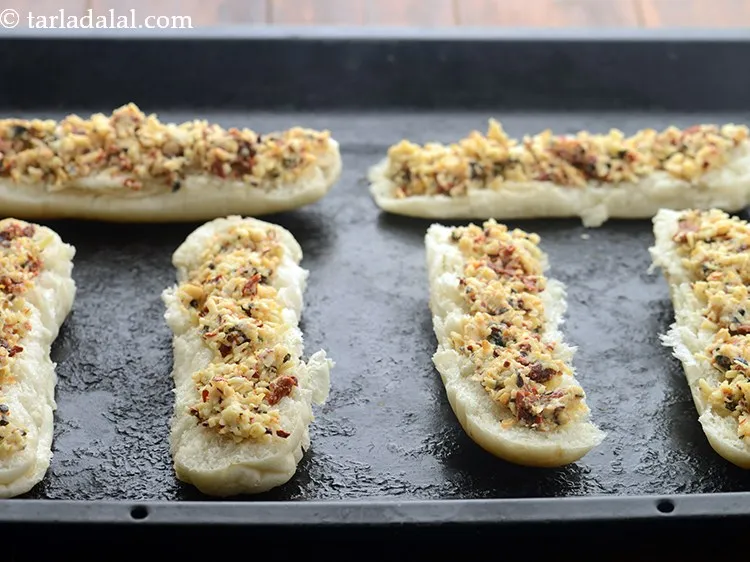 Step 14 – Arrange the hot dog roll halves on a greased baking tray.