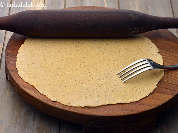 Step 15 – Roll a portion into a 175 mm. (7&rdquo;) diameter circle using a little whole wheat …