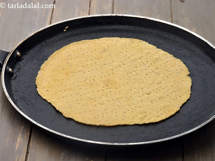 Step 16 – Heat a non-stick tava (griddle) and cook the circle lightly on both the sides.