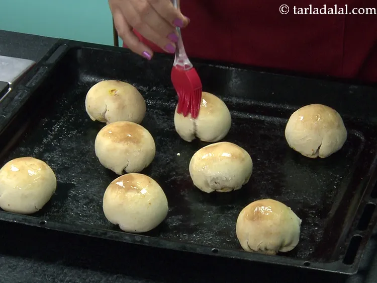 Step 50 – Brush with little&nbsp;<a href="https://www.tarladalal.com/glossary-melted-butter-1941i">melted butter</a>.