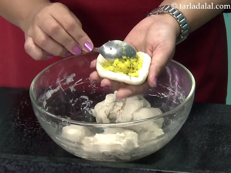 Step 40 – Place a portion of the potato stuffing in the centre.