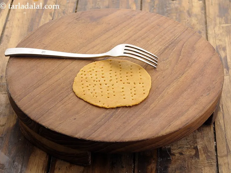 Step 15 – Place 10 puris at a time on it and prick all over using a fork.