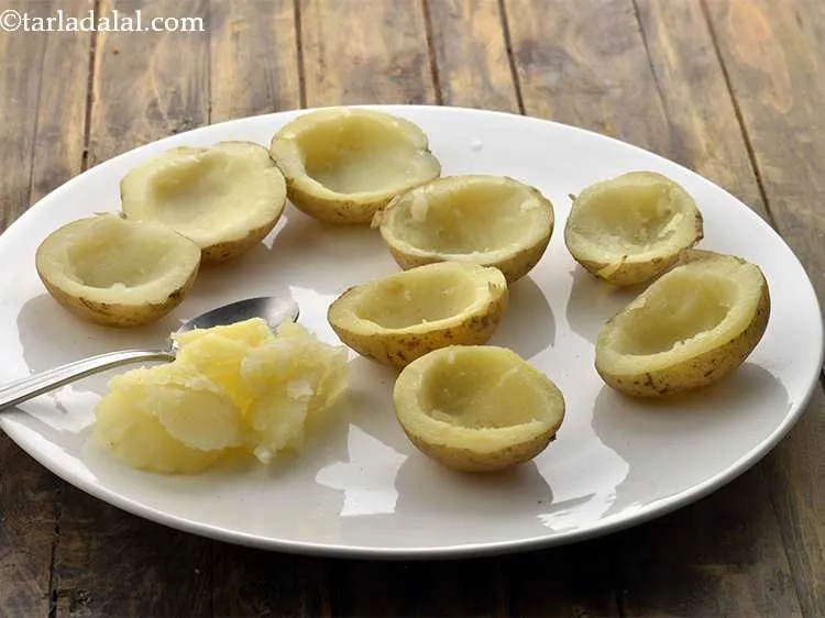 Step 10 – Scoop the potato halves, using a spoon so that a depression is created for the …