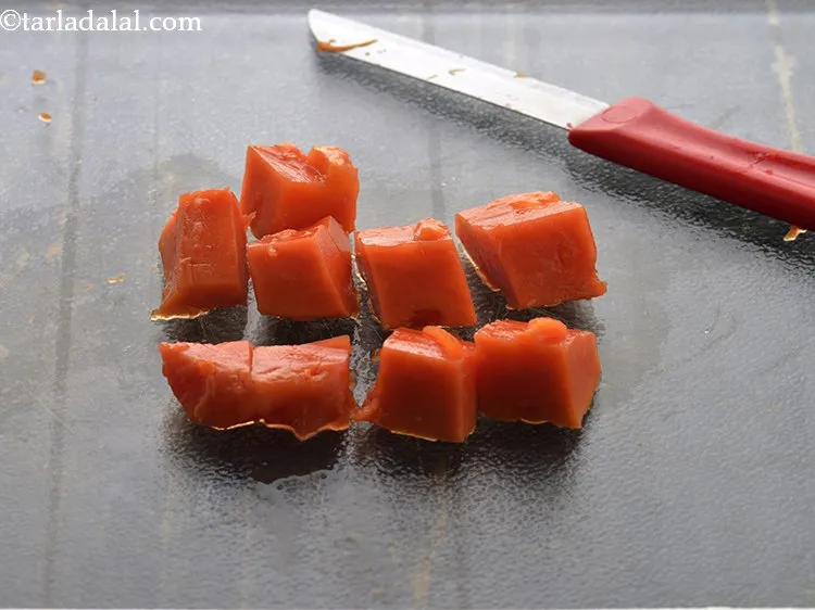 Step 9 – Place the papaya on a clean chopping board and chop it roughly.