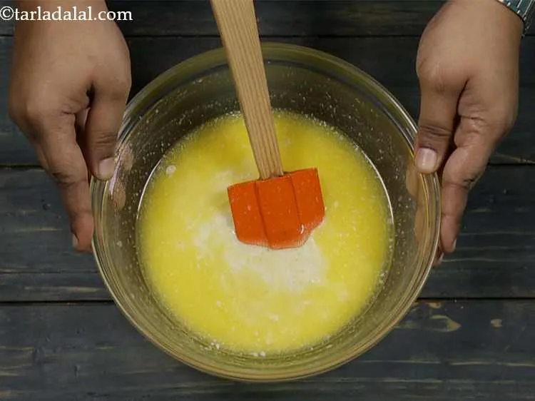 Step 12 – Now add the prepared milk-lemon juice mixture and mix well using a spatula. Keep aside.
