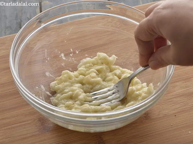 Step 6 – <strong>Mash the banana.</strong> Using a spoon or a fork mash the banana very well. No …