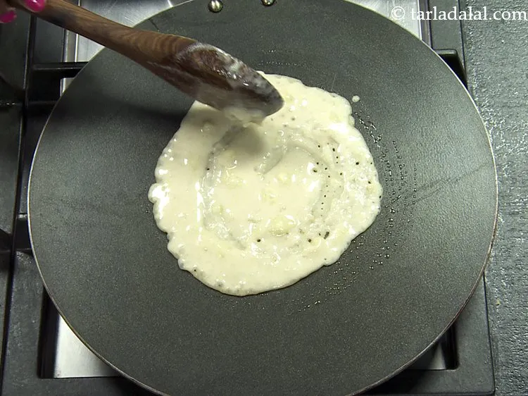 Step 8 – Pour &frac14; cup of the batter on it and spread in a circular motion to …