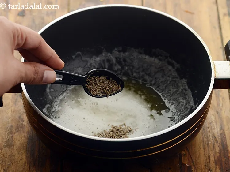 Step 8 – Once hot and melted, add the cumin seeds.