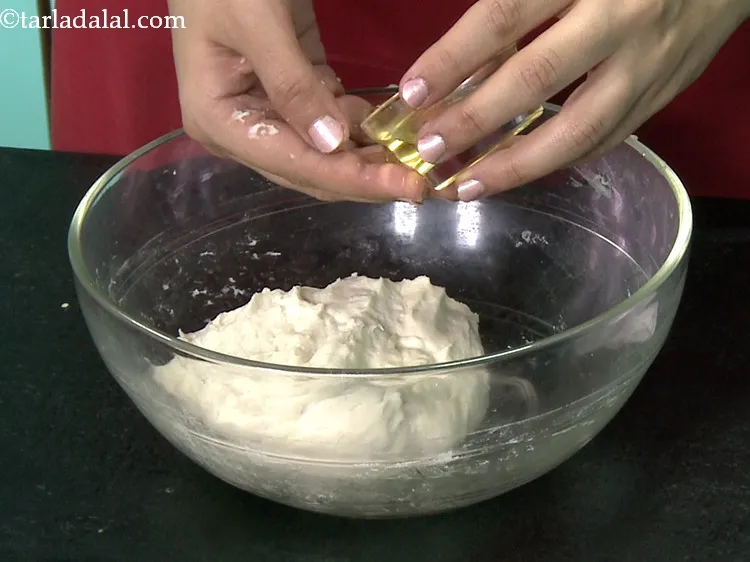 Step 17 – Pour a little olive oil on the dough and also, grease your palms with it.