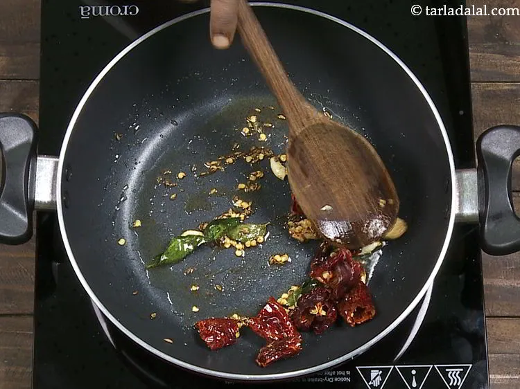 Step 19 – Add dry red chilies and saut&eacute; on a medium flame for 30 seconds.