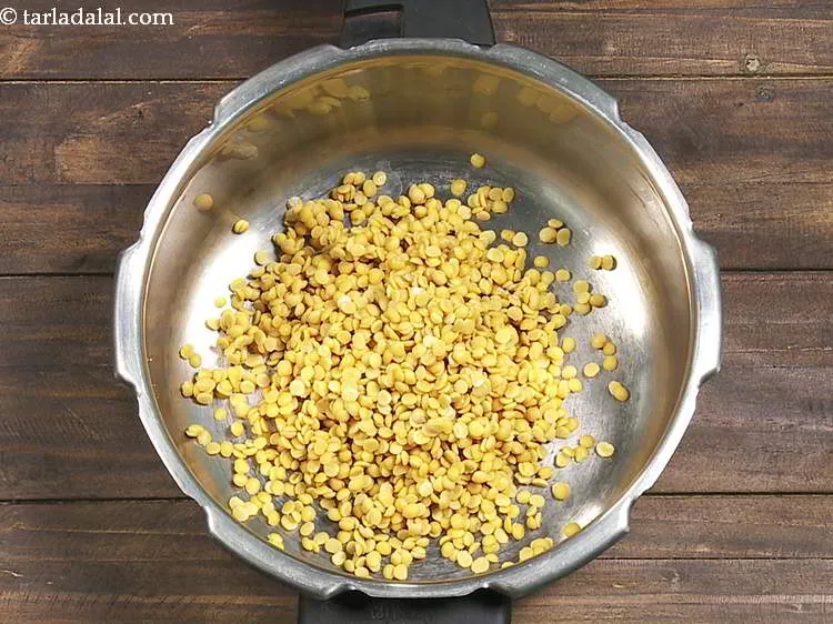 Step 5 – In a pressure cooker, add washed and drained dal.