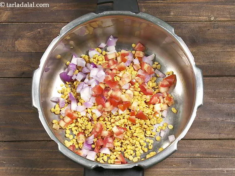 Step 7 – Add tomatoes. Make use of fresh ripe tomatoes to give toor dal a beautiful flavor.