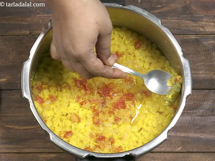 Step 11 – Stir the dal once so there are no lumps and remove the slit green chili.