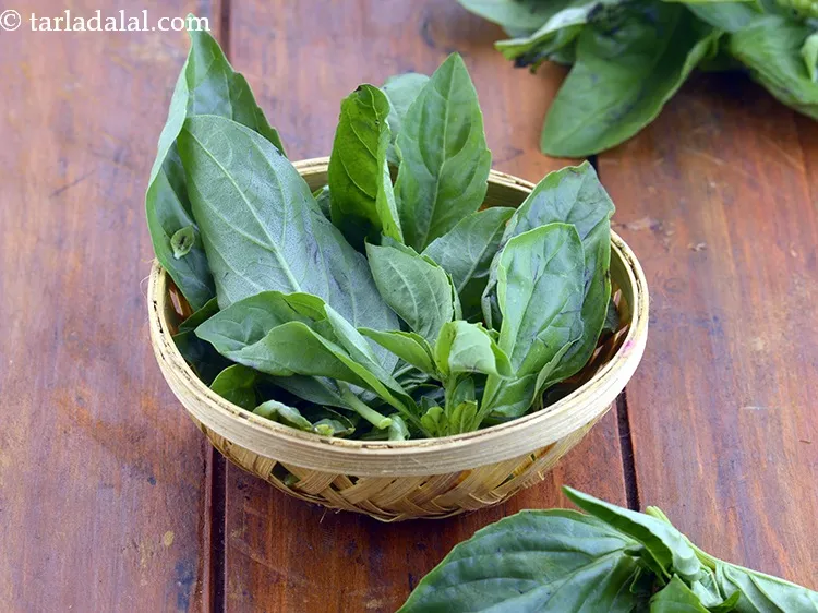 Step 21 – Place 3&nbsp;<a href="https://www.tarladalal.com/glossary-basil-185i">basil</a>&nbsp;leaves, torn into pieces.