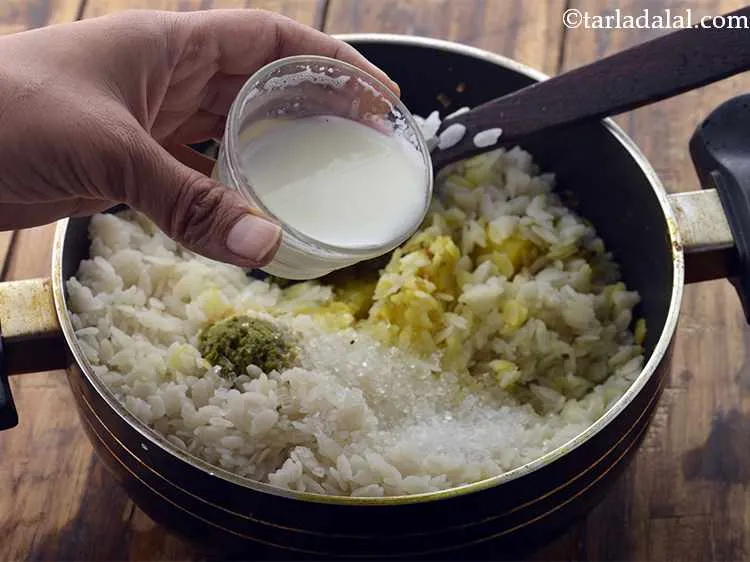 Step 14 – Add milk. Milk provides softness to the <strong>batata poha</strong> on cooking.
