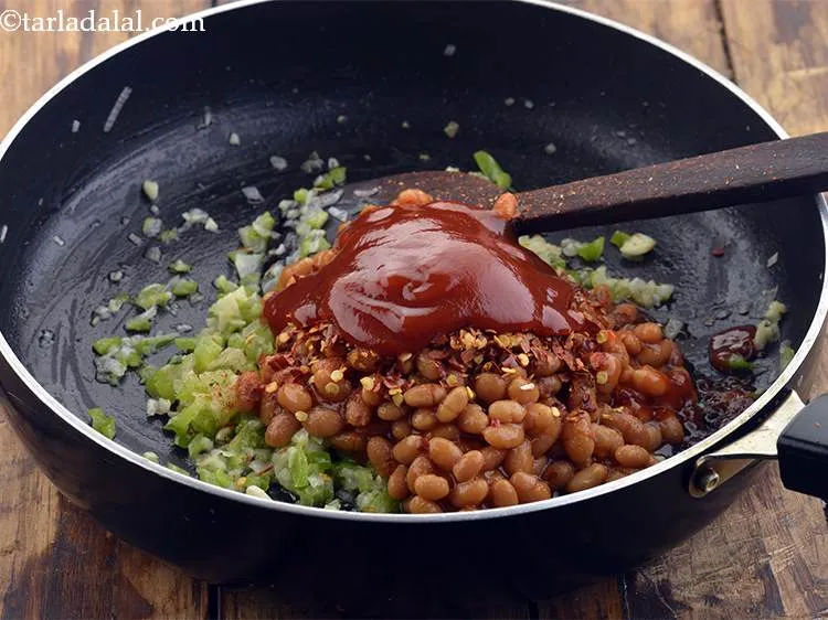 Step 11 – Now, add the tomato ketchup for the mild sweetness it imparts to the topping of&nbsp;<strong>Beans …