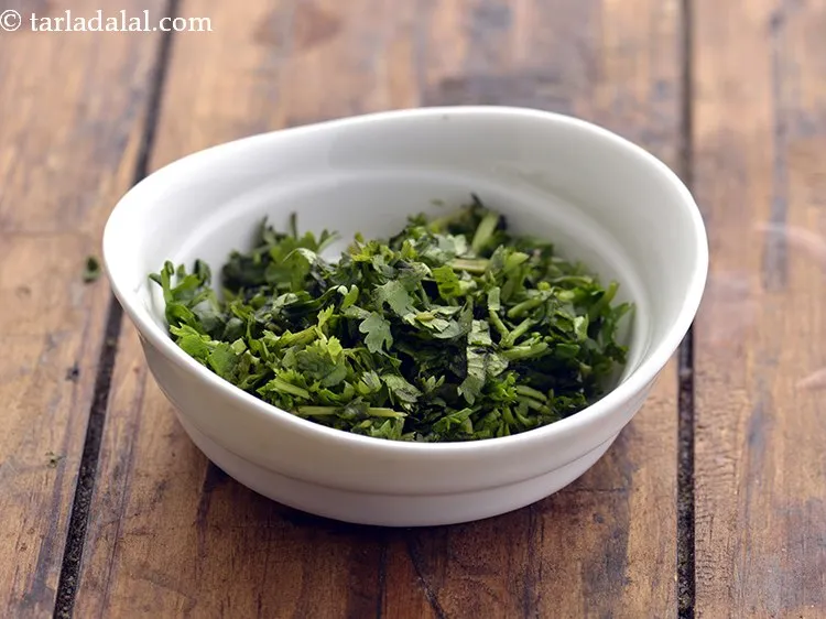 Step 18 – Finely chop the leaves for the raita. We will need only 1 tbsp of chopped …