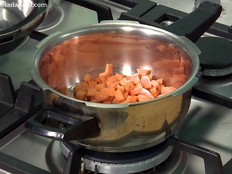Step 10 – Add chopped carrot to the pressure cooker. Wash and peel the carrot before chopping it. …