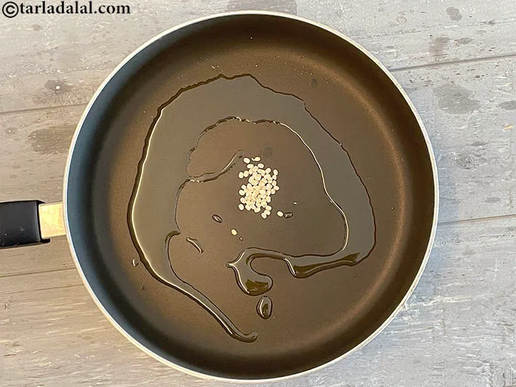 Step 12 – Add&nbsp;<meta charset="UTF-8" />1/4 tsp&nbsp;<a href="glossary-urad-dal-split-black-lentil-941i">urad dal (split black lentils)</a>.