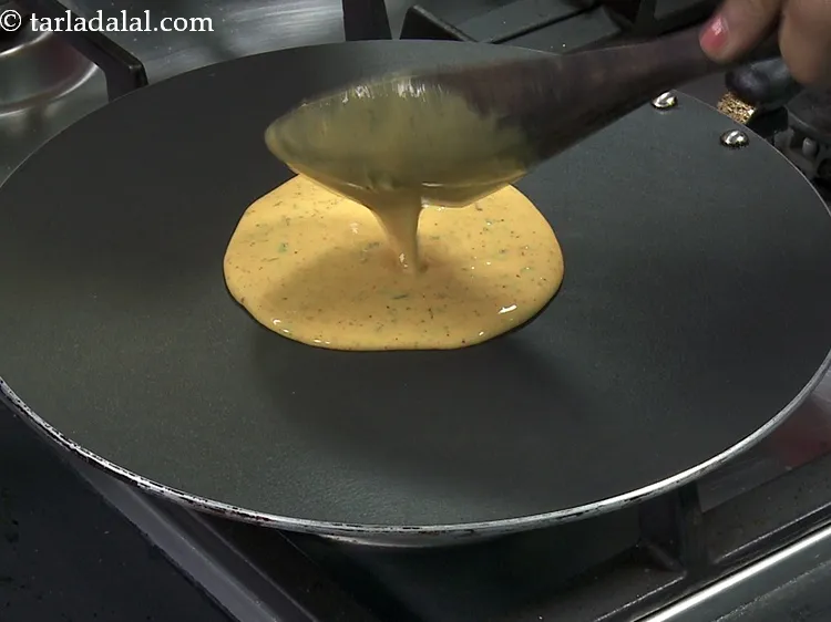 Step 24 – Further, pour a ladle of chilla batter on a non-stick tava, make sure the flame …