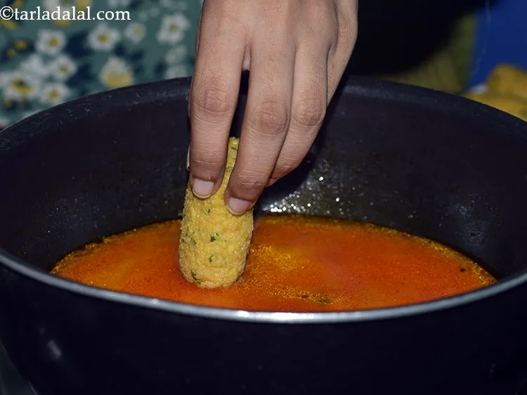 Step 24 – Slowly add the muthias one at a time. When adding muthias to the mixture, add …