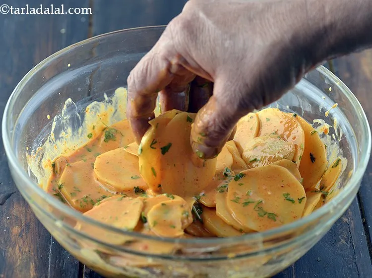 Step 16 – Dip a potato slices in the batter and coat nicely with the prepared batter.