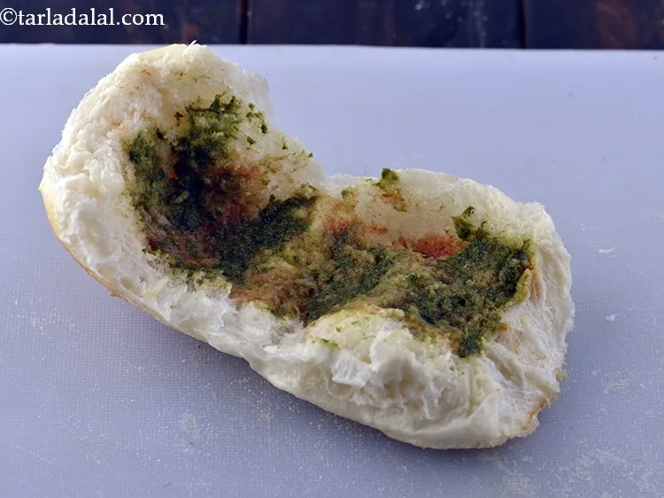 Step 24 – Apply 1 tsp <a href="https://www.tarladalal.com/Green-Chutney-(-Chutney-)-1468r">green chutney</a> on both sides of the pav.