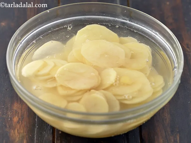 Step 5 – Till the time you are doing other preps, submerge the potato slices in water to …