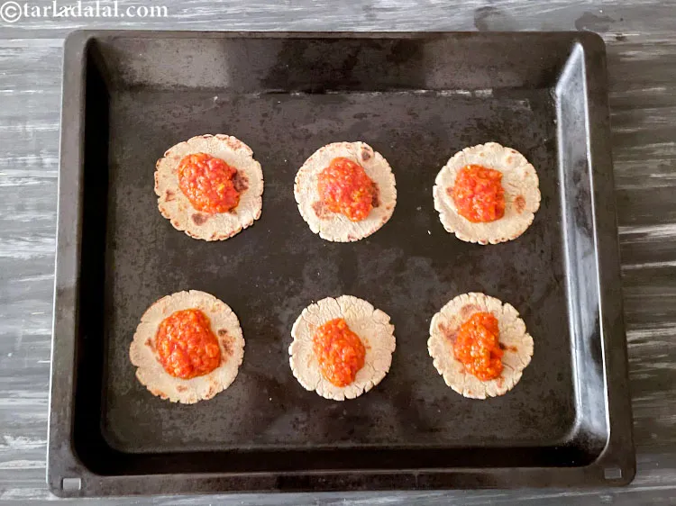 Step 47 – Top with 1 tablespoon homemade pizza sauce.&nbsp;