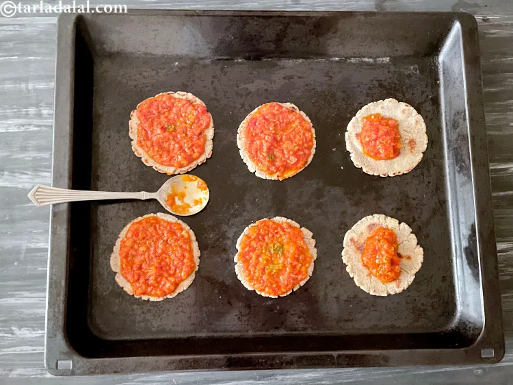 Step 48 – Spread pizza sauce with the back of the tablespoon.