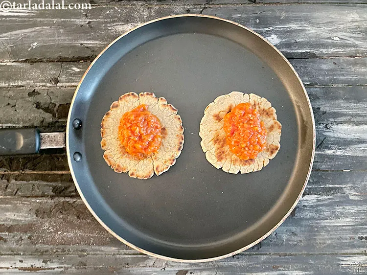 Step 41 – While on the tava (griddle), put 1&nbsp;tbsp of the pizza sauce on the bhakri.