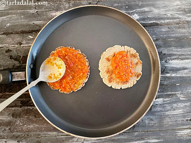 Step 42 – Spread 1&nbsp;tbsp of the pizza sauce on the bhakri with the back of the&nbsp;tablespoon.