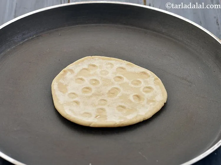Step 14 – Heat a non-stick tava (griddle) and place the rolled <strong>Gujarati bhakri&nbsp;</strong><strong>(Kathiyawadi Bhakri, Gujarati Style Biscuit …